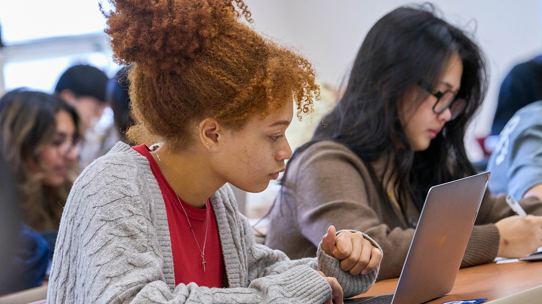 Students working on laptops in a classroom