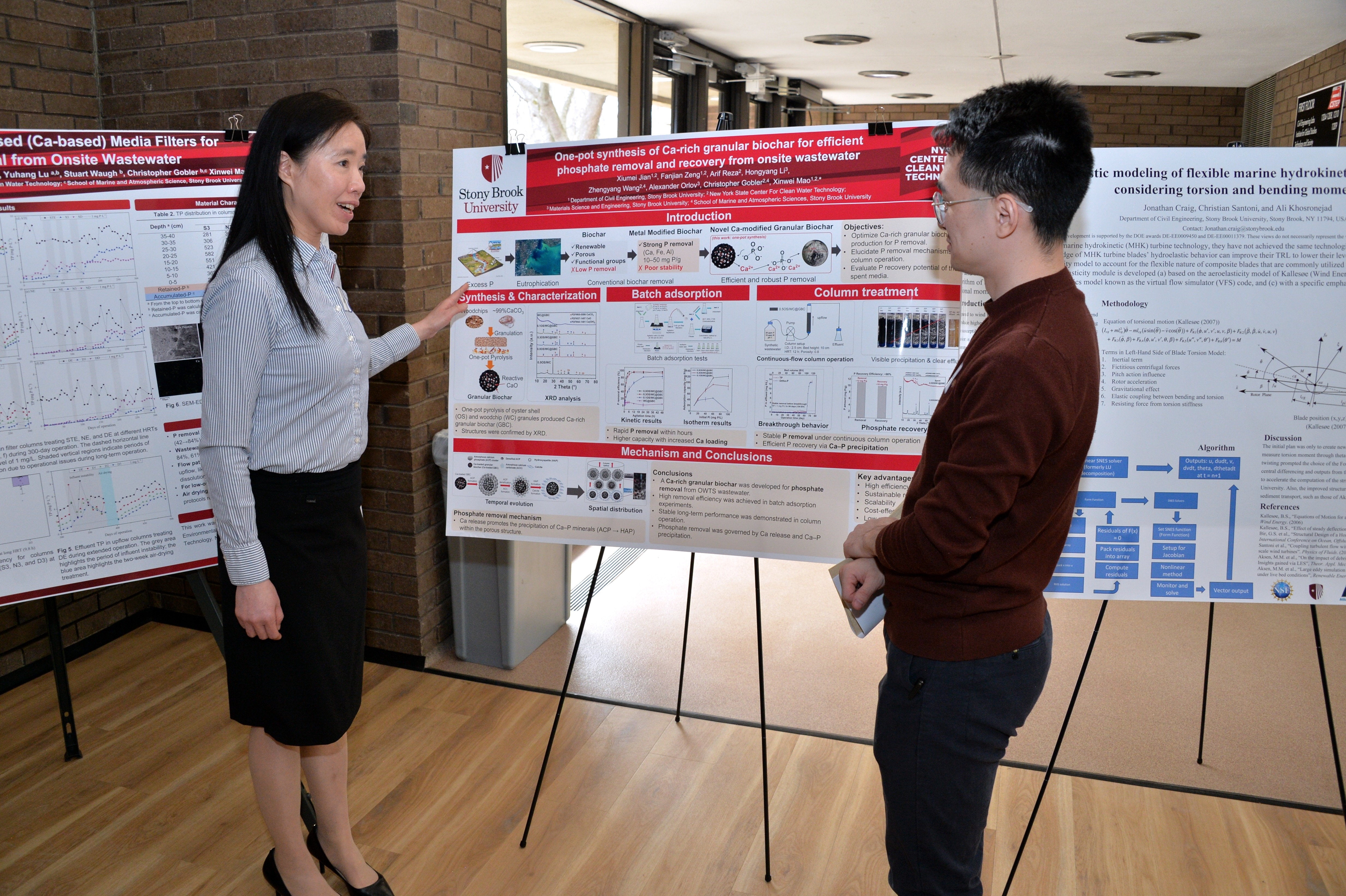 Xiumei Jian presenting her poster to a peer