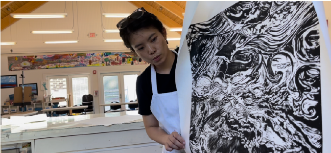 Han Qin working on artwork