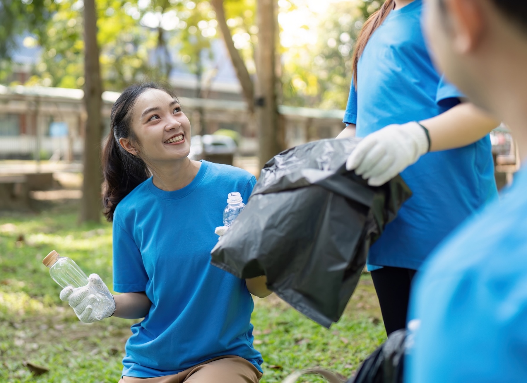 Participant volunteers taking part in a park cleanup project