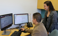 Kristy Bunton  helps faculty member on computer